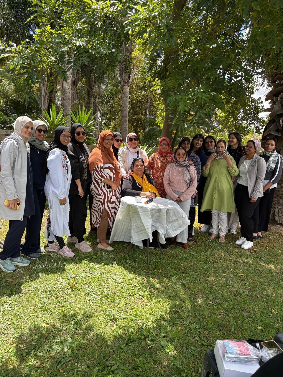 Sisters gathered under the trees at a community garden event