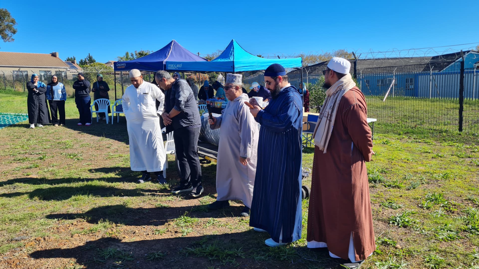 Imams and community members gathered on the masjid land